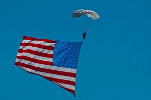 Image:  Dana Bowman, Veteran & double leg amputee, parachuting in on grand opening.