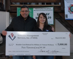 VMSI's Emily Wilson presents a $5,000 check  to Ken Falke, Founder of Boulder Crest Retreat