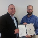 Ken Konkol (left) presents an Award of Excellence to Brian Davids for his first-class support.