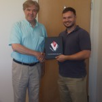Gary Golinski presents Martin McPherson  with an award for his commitment  to fulfilling the VA’s needs.