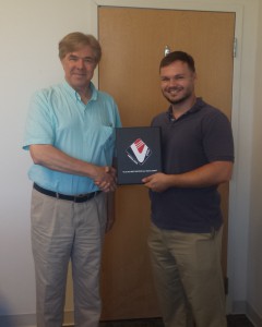 Gary Golinski presents Martin McPherson  with an award for his commitment  to fulfilling the VA’s needs.
