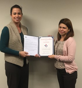 VMSI Team Lead, Lauren Hoffman,  presents an Award of Excellence to Vicky Guillot.