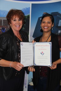 VMSI Team Lead, Jennifer Johnson,  presents an Award of Excellence  to Joy Richardson.