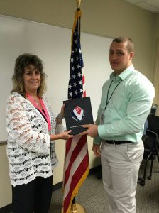Patti Rice presents Award of  Excellence to Justin O’Neill