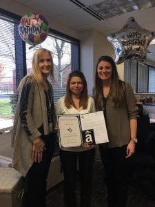 Kathy McKenzie (left) and Megan Shelton (right) recognize Vicky Guillot.