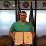 Kenneth Stephens displays  his Award of Excellence