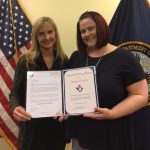 Kathy McKenzie, left, presents an Award of Excellence to Shannon Christy