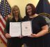 Kathy McKenzie, left, presents an Award of Excellence to Shannon Christy