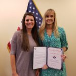 Kathy McKenzie (right) is presented  with an Award of Excellence.