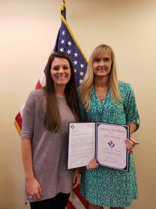 Kathy McKenzie (right) is presented  with an Award of Excellence.