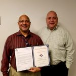 VMSI COO, Ken Konkol (right), recognizes Charles Owens for his stellar performance.