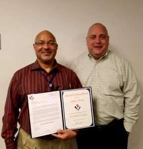 VMSI COO, Ken Konkol (right), recognizes Charles Owens for his stellar performance.