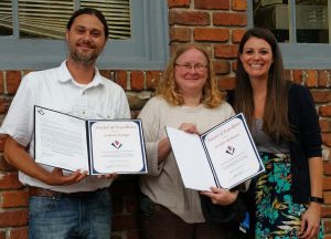 Megan Shelton (right), presents  Awards of Excellence to Zac and Jennifer