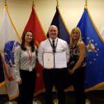 VMSI PM Emily Wilson (far left) and Kathy McKenzie (far right), present an award to Paul Tschiffely.