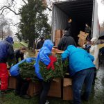 Volunteers handing out wreaths