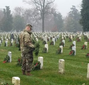A soldier laying wreaths