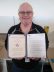 Rick Burgard receives an Award of Excellence for contract closeout support.