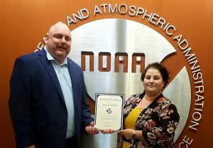 Ken Konkol, COO, presenting Pearl Chamberlin with an Award of Excellence.